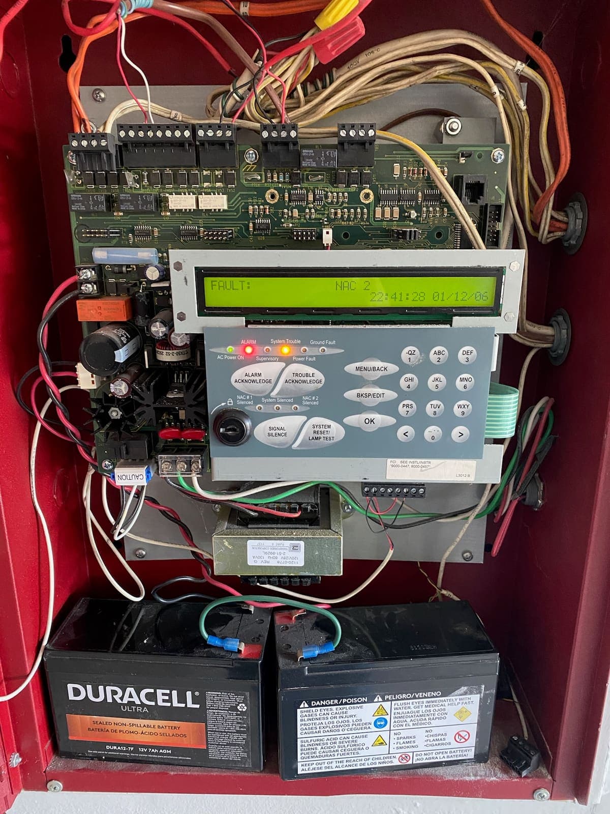 Fire alarm control panel open for service, trouble condition on the display