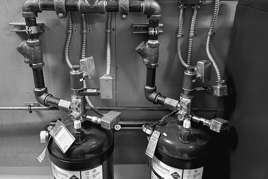 Clean agent suppression cylinders installed in a protected equipment room