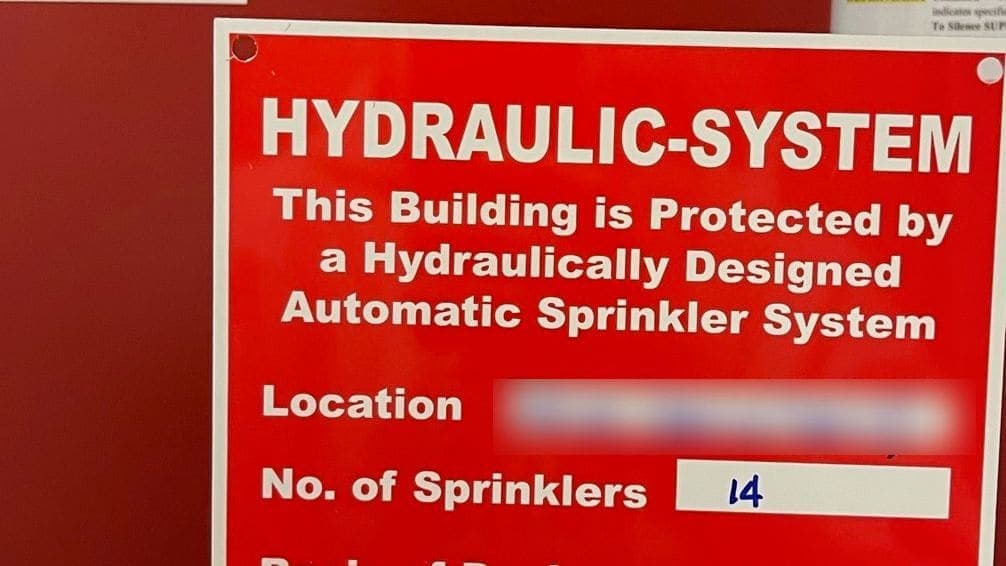 Hydraulic design placard listing sprinkler density, design area and system demand