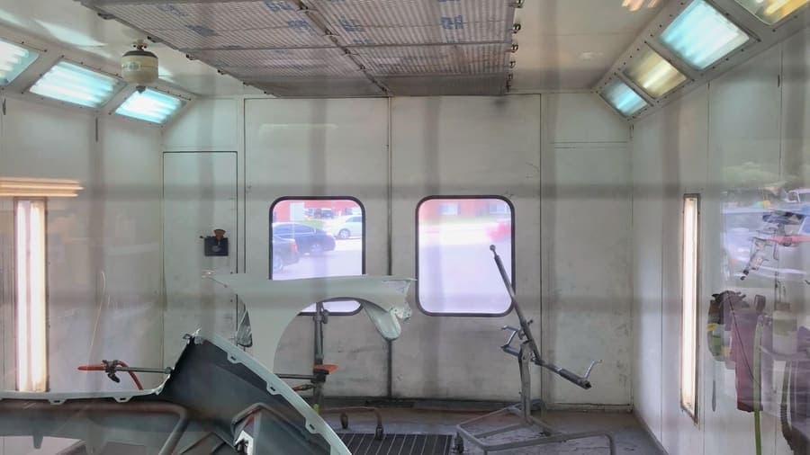 Automotive spray paint booth with suppression coverage
