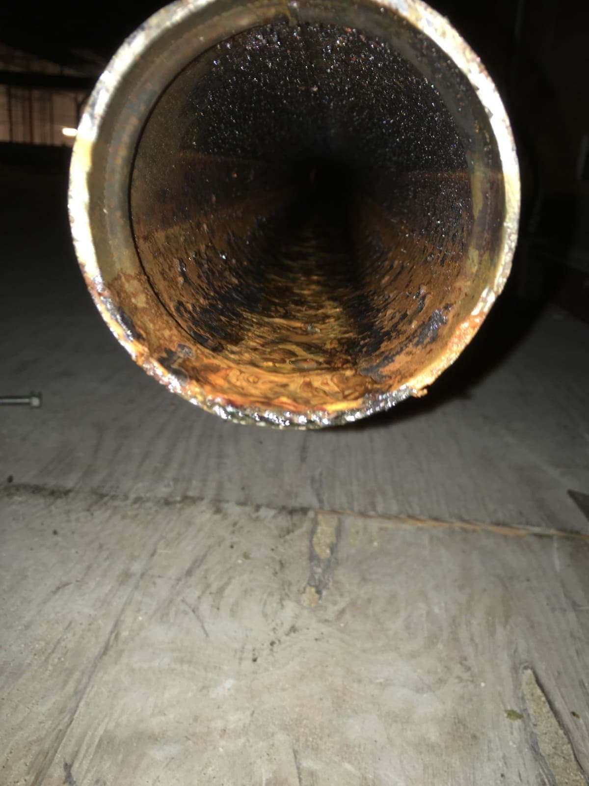 Looking into the bore of a sprinkler pipe with corrosion restricting the opening