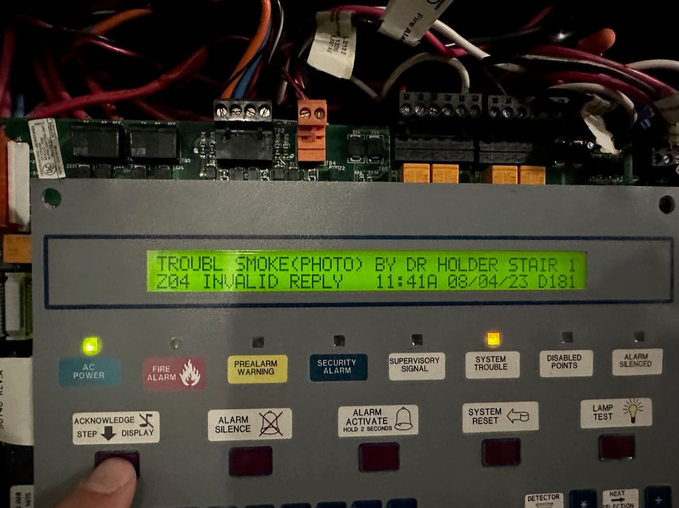 Technician stepping through a trouble signal on a fire alarm panel display